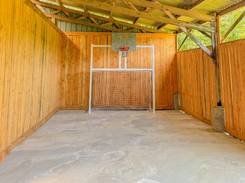 Terrain de sport couvert : panier de basket et but de foot